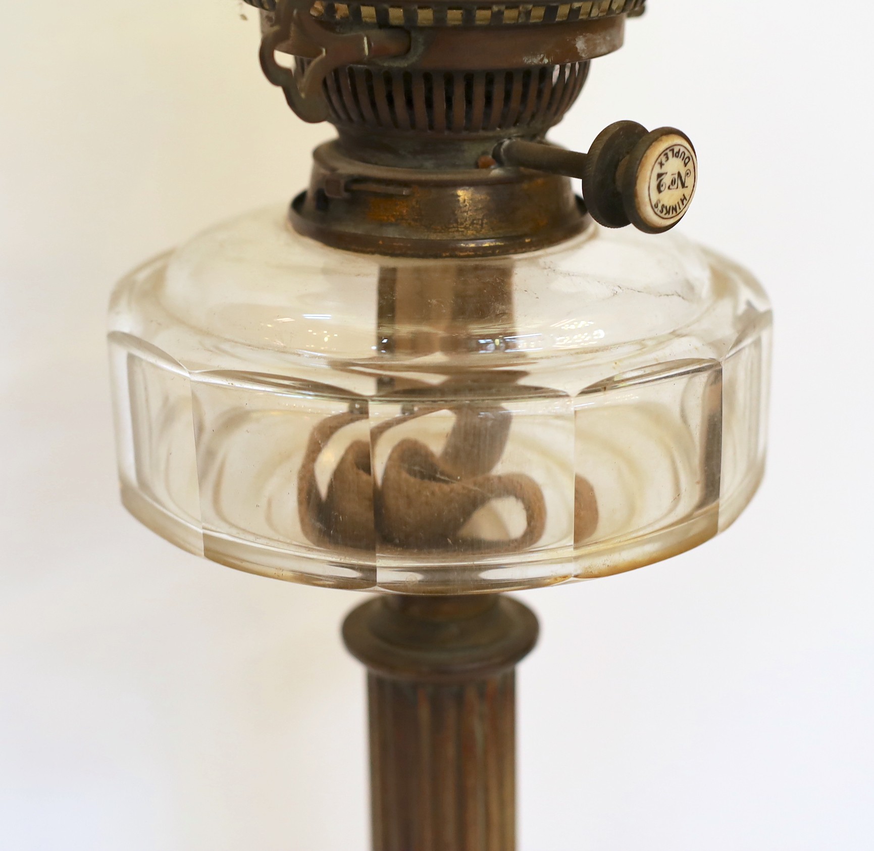 An Edwardian brass oil lamp with cut glass reservoir, Hinks No2 duplex mechanism, Vaseline shade and flue, height overall 67cm